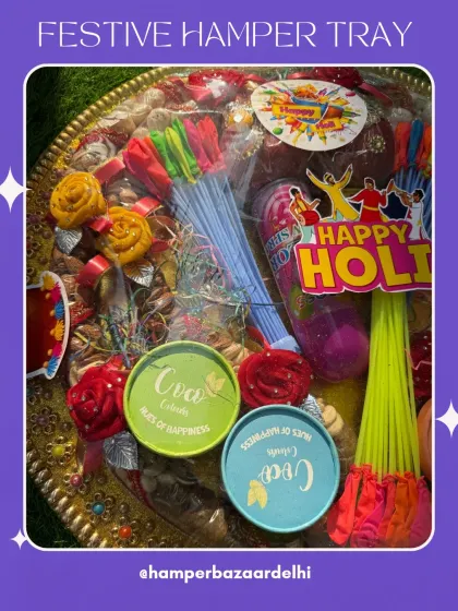 Our festive hamper tray is perfect for a grand Holi gesture. It's loaded with dry fruits, gulal, water balloons, and other festive delights, all beautifully wrapped and ready to gift.