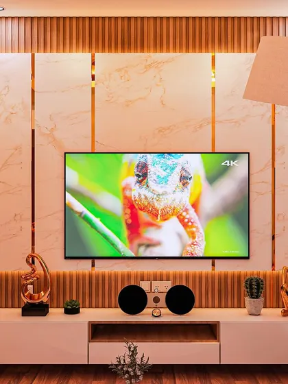 This render shows a concept for a TV unit with a marble and fluted wood back-panel. The gold inlay and warm backlighting create a luxurious focal point for the living room.