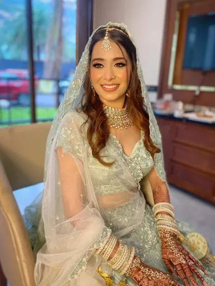 My beautiful bride Aashna, glowing in a unique mint-green lehenga for her wedding day. The makeup was kept soft and romantic to match the pastel tones of her outfit.