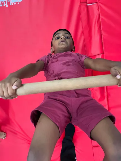 The look of intense focus. This student is working on his pull-ups, building the upper body strength that is crucial for so many gymnastics skills. We celebrate the effort as much as the result.