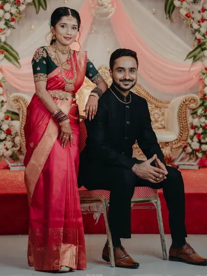 The couple sharing a moment at their wedding. The bride's custom blouse was designed to perfectly match her traditional saree.