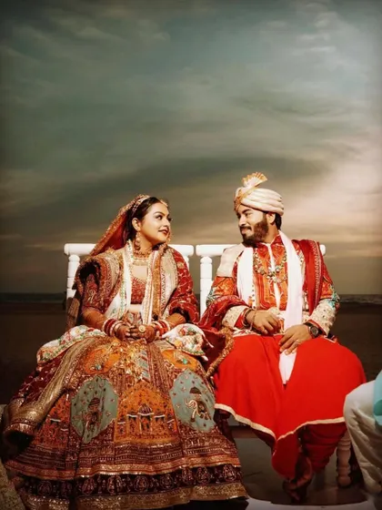 An artistically edited shot of the couple at their beach wedding, creating a dramatic and timeless portrait.