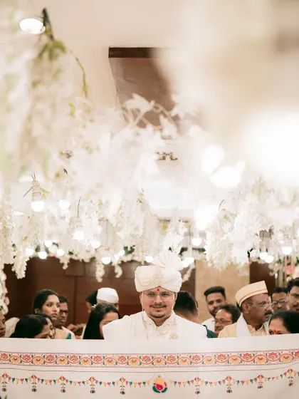 The groom's view, waiting for his bride as the antarpat, the ceremonial cloth, is held between them.