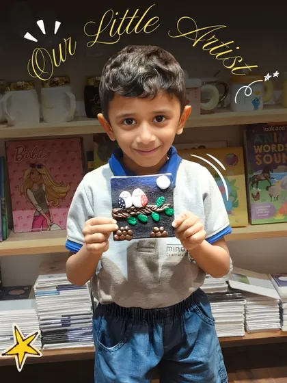 An adorable young boy, framed by the words "Our Little Artist," smiles as he shows off his handmade clay art.