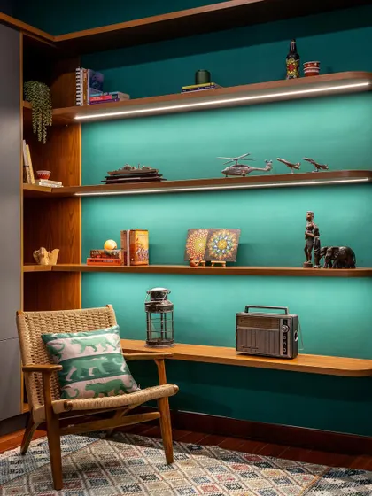 The curios unit in the 'Vasudhalayah' home office is washed in a rich emerald green. The floating, backlit shelves beautifully display the family's heirlooms and collectibles.