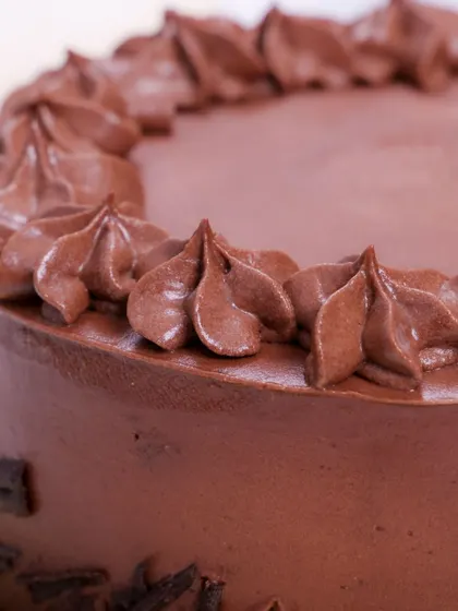 We offer a classic indulgence with our rich chocolate layer cake. Alternating layers of vanilla sponge and deep chocolate fudge frosting are covered in a smooth chocolate ganache, creating a simple yet profoundly satisfying dessert.