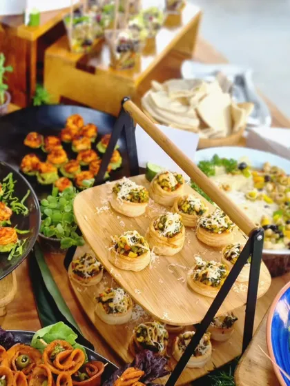 A beautiful tiered display of our spinach and corn tartlets. These savory pastries are a delicious vegetarian option, perfect for high tea or as part of a larger appetizer spread.