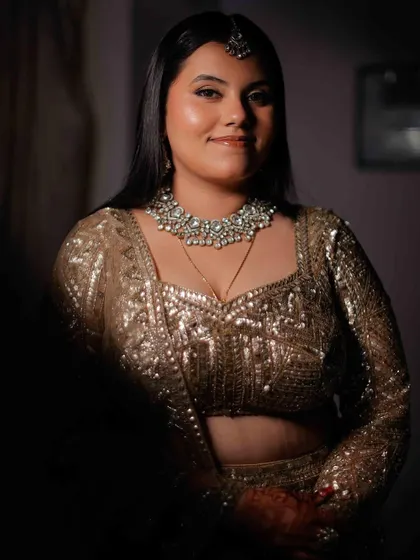 A portrait of pure joy and sparkle. For this bride's reception, we went with a luminous skin finish and soft eyes to complement her dazzling sequined lehenga, letting her happy glow be the centerpiece.