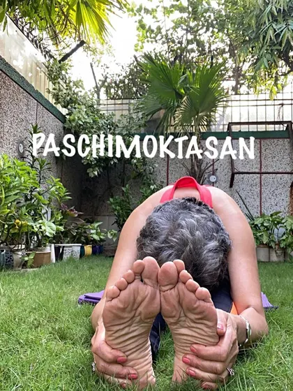 Practicing Paschimottanasana outdoors. Connecting with nature while doing a forward bend enhances the feeling of grounding and release.