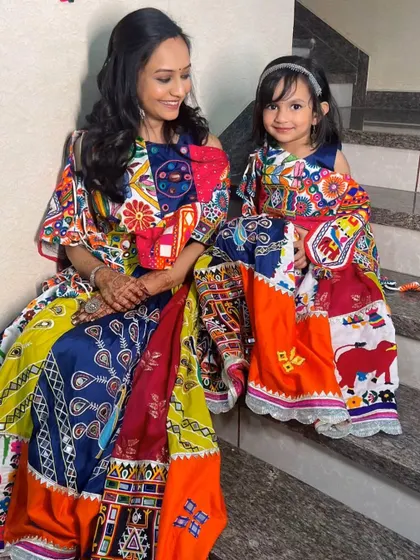 A beautiful mother and daughter duo in matching traditional Gujarati outfits for a Padhan ceremony.