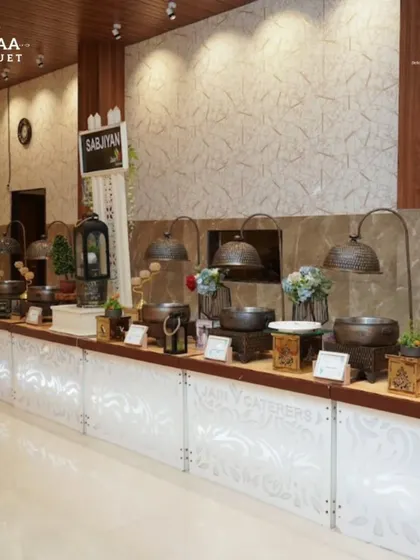 A rustic-themed buffet setup at Tiaraa Banquet. The use of dark wood, antique-style lamps, and textured panels creates a warm and inviting atmosphere for guests.