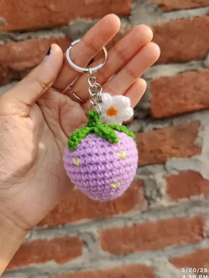 Sweet strawberry and daisy keychains. These come in red, pink, and purple, each with a little white flower.