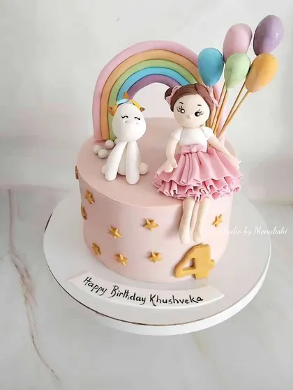 A pretty unicorn themed cake for Khushveka's 4th birthday. It features a little girl figurine, a unicorn, a rainbow, and a bunch of pastel balloons.
