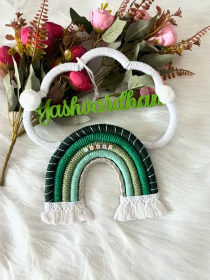 The 'Yashwardhan' name hanging styled with flowers, showing how it can be a beautiful centerpiece for room decor.
