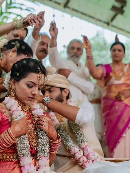 A beautiful moment during the wedding ceremony, with guests showering the couple with blessings and petals. We capture the collective joy of everyone involved.