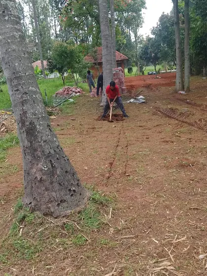 A duplicate image of the initial groundwork, with a team member marking the path layout.