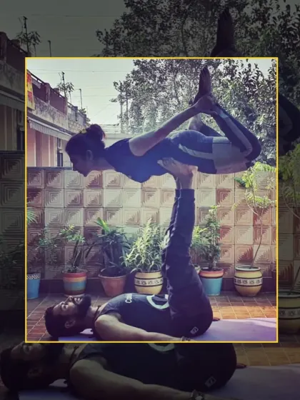 The flyer holds a beautiful Dhanurasana (Bow Pose) while being balanced on the base's feet. This is an advanced acro yoga pose requiring great control.