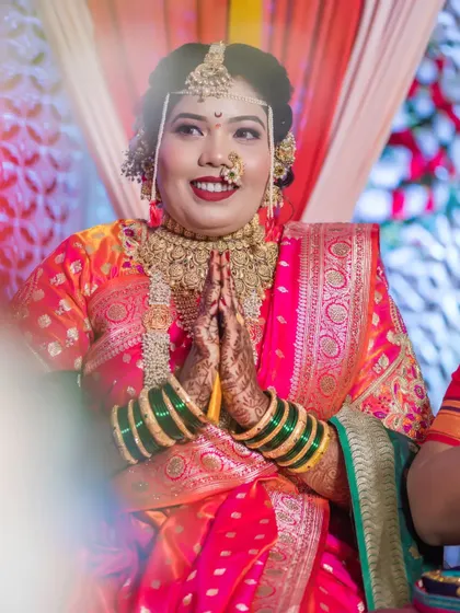 The bride offers a prayer with her hands joined, a moment of reverence and grace on her wedding day.