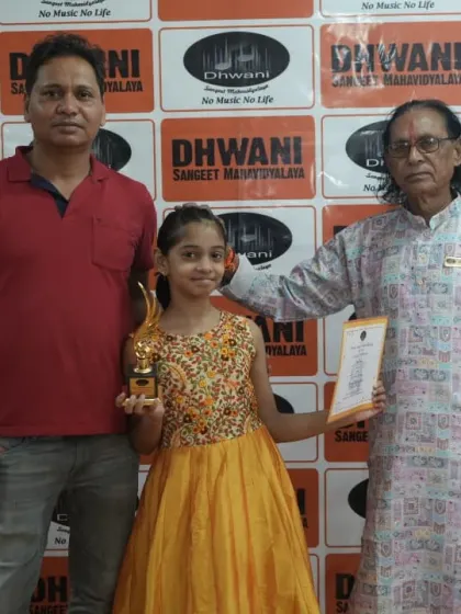 A student receives her award from one of our senior gurus. We honor the tradition of learning from experienced masters of the art.