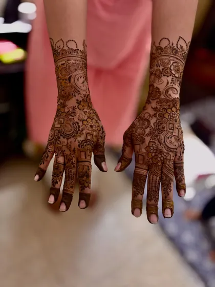 A designer mehndi for a beautiful client, Amina. The pattern is intricate and covers the back of the hand, perfect for a special event.