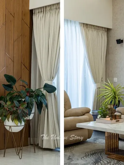 Detail shots of the living room, focusing on the contrast between the geometric wood-paneled TV wall and the soft, plush recliner sofas. Potted plants and decorative objects on the console add a personal and fresh touch.
