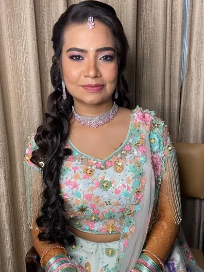 A full seated view of this pretty sangeet look. The makeup is fresh and youthful, perfect for a night of celebration.