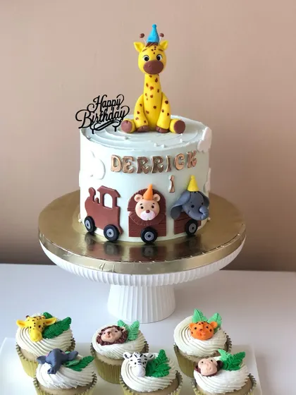The full dessert spread, with the animal train cake and matching safari animal cupcakes.