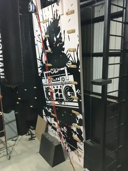 Our boombox mural painted on a climbing wall, integrating the artwork directly into the gym's functional equipment. The design adds a dynamic visual element to the climbing experience.