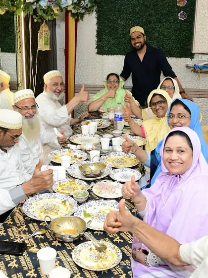 Thumbs up from a happy family enjoying a traditional meal.