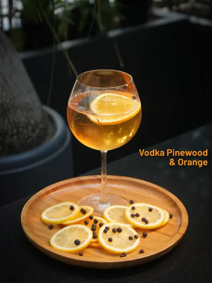 From a promotional menu, the Vodka Pinewood & Orange cocktail, a bright and aromatic drink.