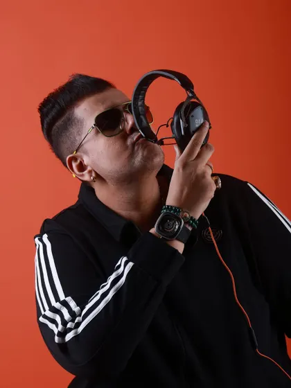 Kissing my headphones, a symbol of my love for music. This is more than a job; it's my life's passion.