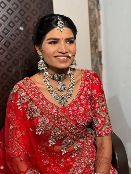 A bright, joyful smile from the bride. The makeup is designed to enhance her features and radiate happiness.