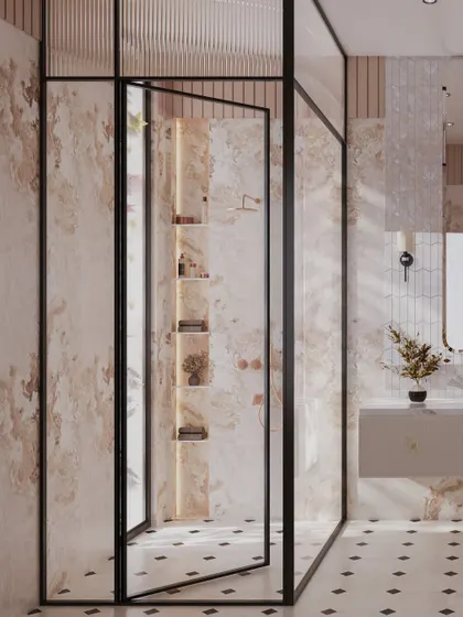 The walk-in shower is enclosed by a black-framed glass partition, adding a modern contrast to the soft, feminine materials. Inside, illuminated niches provide elegant storage for bath essentials.