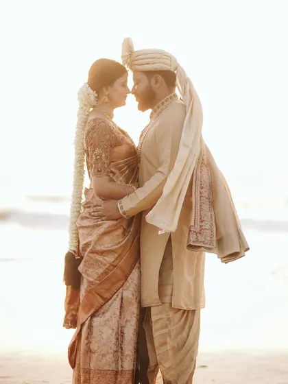 A romantic silhouette of a couple against the setting sun on a beach. This kind of shot is perfect for capturing the dreamy, magical feeling of a destination wedding.
