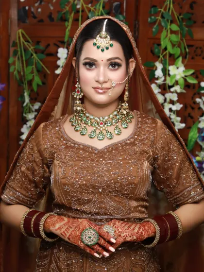 A stunning bride in a brown lehenga, showcasing a complete and cohesive look from head to toe.