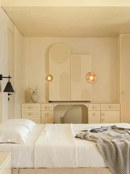 A wider view of the Soft Serve master bedroom, showing the serene, monochromatic color scheme and the focus on clean lines and soft textures.