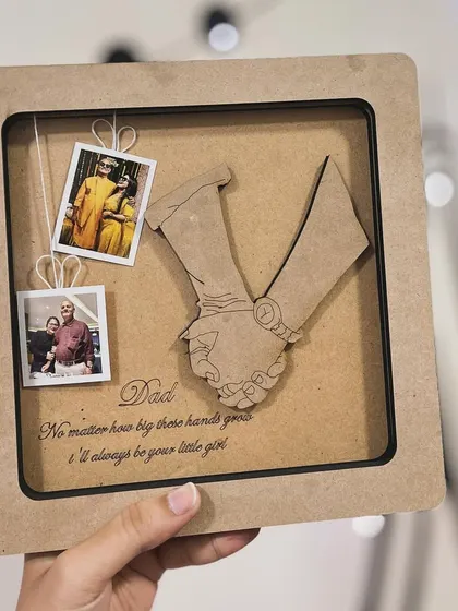 A clear shot of the personalized 'Dad' frame, with the engraved message "No matter how big these hands grow, I'll always be your little girl."