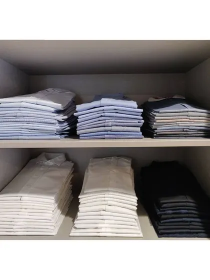 Perfectly stacked shirts in a man's closet. This level of organization saves so much time in the morning.