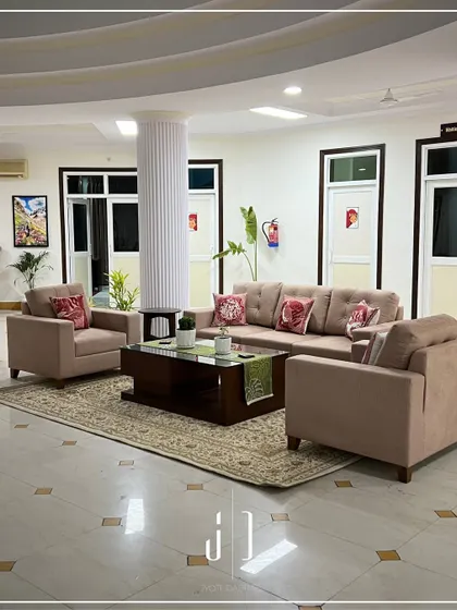 A comfortable and modern seating arrangement in the guest house lounge. I chose a neutral color palette with pops of color in the cushions to create a relaxing yet sophisticated vibe.