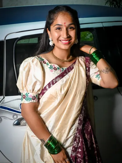 A client looking lovely in a cream and maroon half saree with puff sleeves. This traditional Langa Davani is a wonderful choice for family gatherings and festive celebrations.