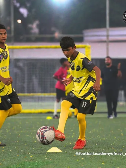 Two players work on their ball control skills side-by-side. I encourage a focused and disciplined atmosphere during drills.
