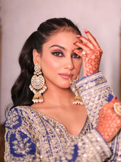 A close-up of our royal blue lehenga, showing the intricate silver embroidery and traditional jewelry.