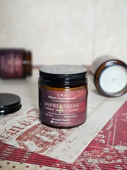 My 'Impressions' Amber Jar Candle, a bestseller with its unique blend of fresh, woody, and ocean notes. It's designed to embody style and leave a lasting impact.