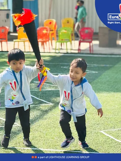 Teamwork makes the dream work. Two boys run together during a relay race on our 'Health is Wealth Day', learning about cooperation and sportsmanship.