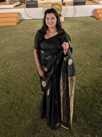 Black is always a statement. This client is wearing a classic black saree with a custom-designed blouse featuring subtle embroidery on the sleeve for an elegant touch.