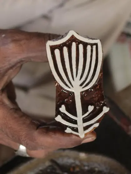 An artisan holds up a newly carved block, inspired by the art of Jessica Campbell. This piece is part of a unique set of prints we developed for our annual workshop collaboration with the Fabric Workshop Museum in Philadelphia.