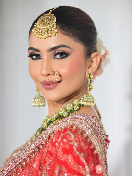 A side profile that highlights the clean, sharp lines of the eye makeup and the radiant finish on the skin. This is a timeless and classic bridal portrait.