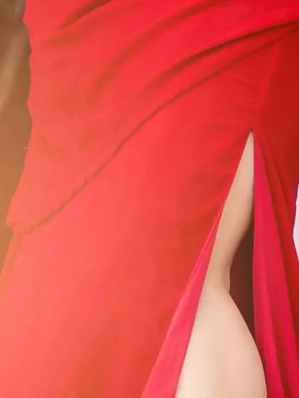 A close-up of the high slit on the red gown.