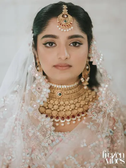 A stunning close-up portrait of the Sikh bride. The focus is on her beautiful, traditional jewelry and her calm, confident expression.