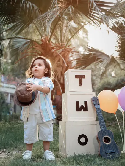 A stylish two-year-old posing during his outdoor birthday photoshoot. We capture both posed and candid moments during our toddler sessions.